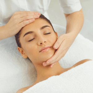 A serene woman receiving a facial massage at a spa, promoting relaxation and skincare.
