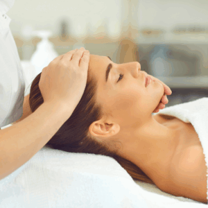 A serene woman receiving a soothing spa treatment with her eyes closed, enjoying relaxation.