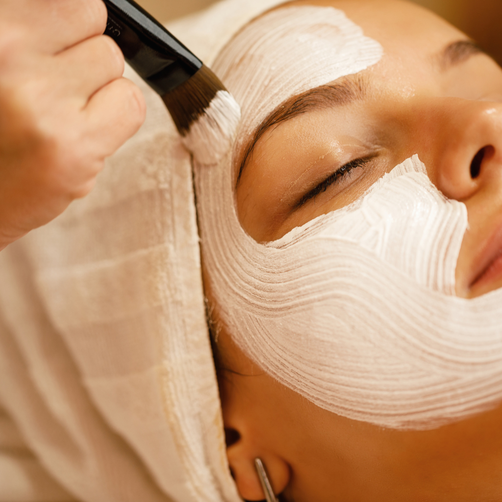 Relaxing facial treatment with soothing mask applied to a client's skin.