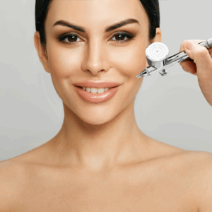 Woman receiving a professional facial treatment with an airbrush at a spa.