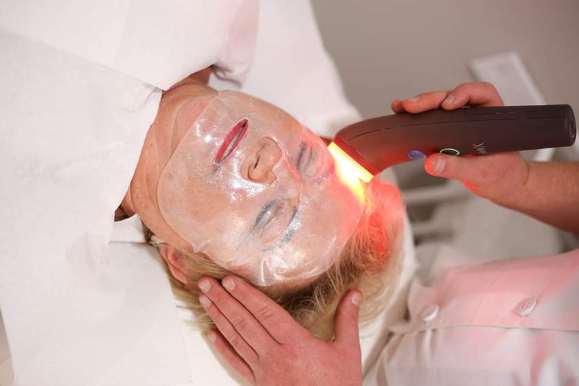 Person receiving a relaxing facial massage with a cream-based treatment.